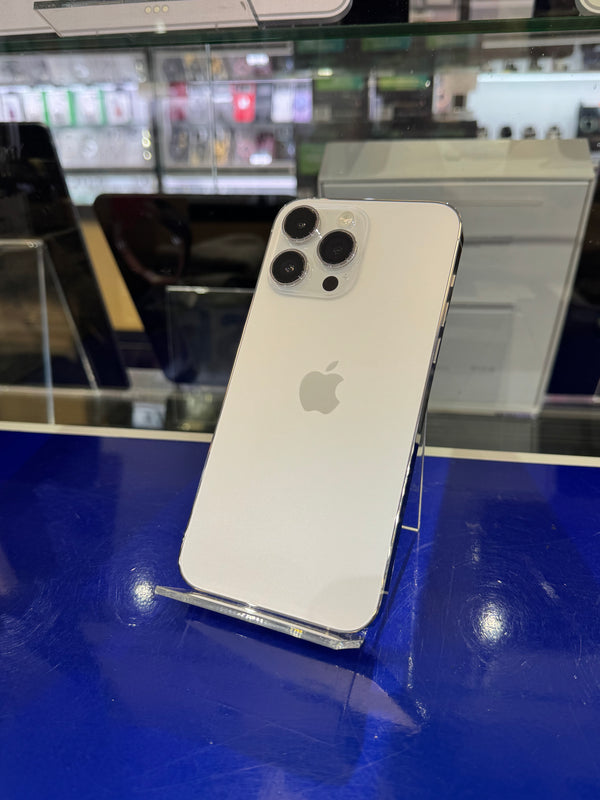 Back view of an Apple smartphone on a blue surface with blurred background