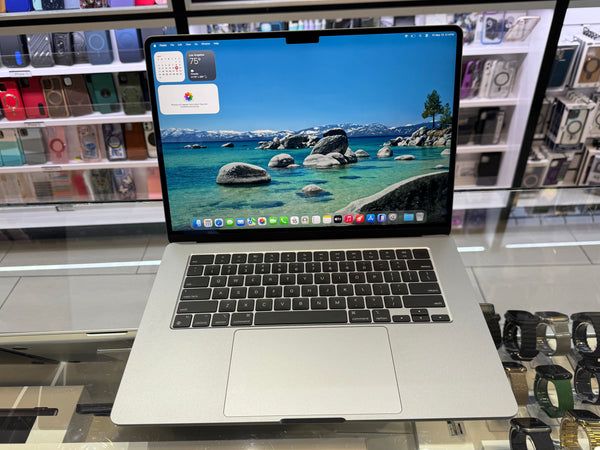 Laptop on display in a store with a scenic screen