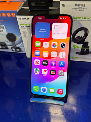 Smartphone with app icons displayed on a blue surface
