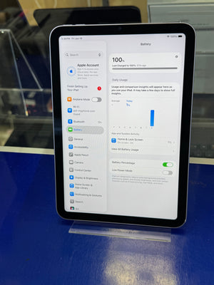 Tablet displaying a settings screen on a stand with a blue background