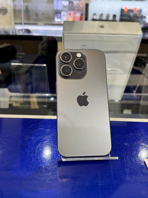 Silver iPhone on a stand with blurred store interior in the background