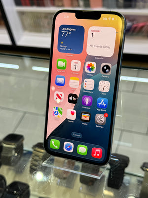 Smartphone with app icons displayed on a reflective surface
