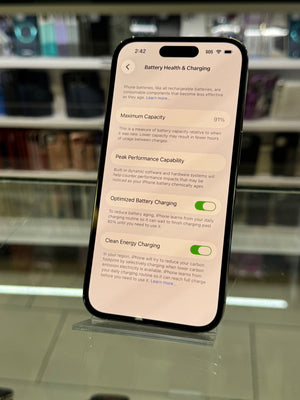 Smartphone displaying a battery information screen with a blurred indoor background