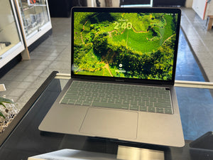 Laptop on a glass surface with a green screen display