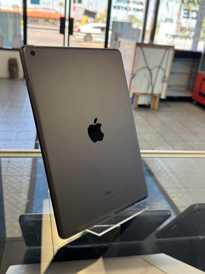 Black Apple tablet on a stand with a blurred background