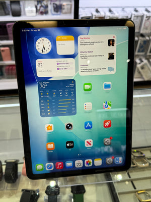 Tablet displaying a variety of app icons on a screen with a blurred background