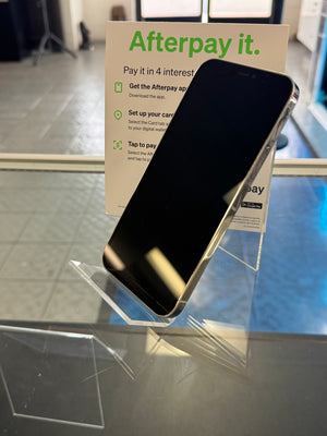 Phone with Afterpay promotional card on a glass surface