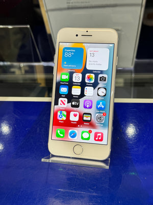 Smartphone with app icons displayed on a reflective surface