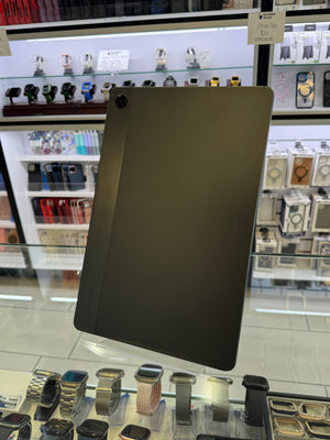 Black tablet on a reflective surface with blurred background