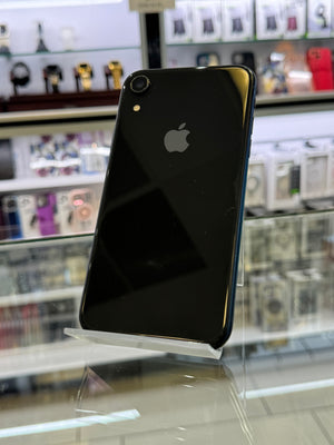 Black smartphone with Apple logo on a reflective surface