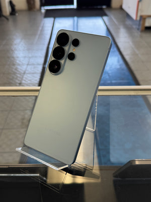 Smartphone held up against  a blurred background