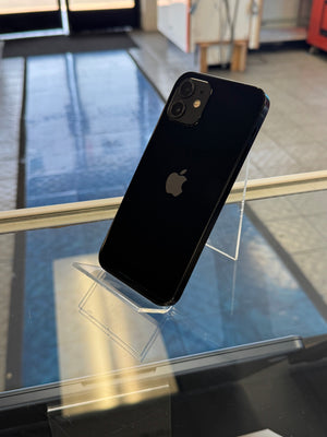 Black smartphone on a stand with a blurred indoor background