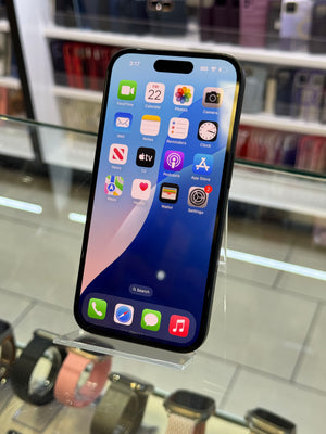 Smartphone with app icons displayed on a stand in a store setting