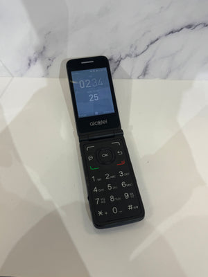 A dark flip phone with a grey screen and a dark keypad against a white background. 