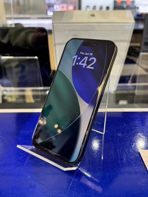 Smartphone on a stand with a blue screen displaying the time and date in an indoor setting.