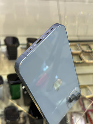 Smartphone displaying charging port on a stand with a blurred background