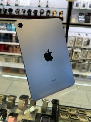 Back view of an iPad with a blurred store interior in the background