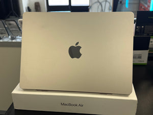  MacBook Air laptop on a white box with Apple logo in a store setting