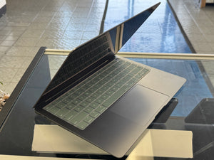 Open laptop on a glass table with a reflective surface