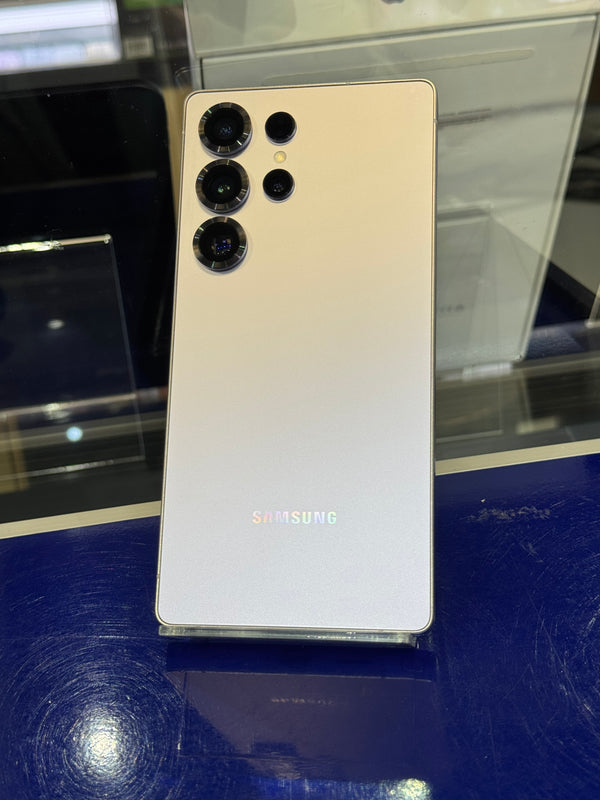 Samsung smartphone with silver back panel on a reflective surface