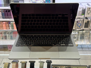 Open laptop on a glass surface with a blurred store background