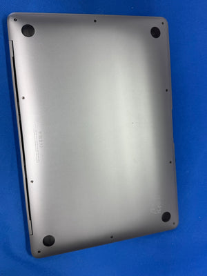A silver aluminum laptop bottom cover with pre-drilled screw holes, shown on a blue background.
