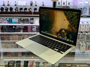 Laptop on display in a store with various electronic items in the background