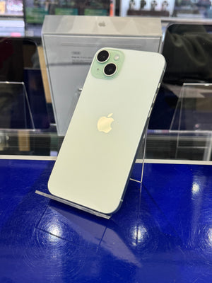 Green Apple smartphone on a blue surface with a blurred background
