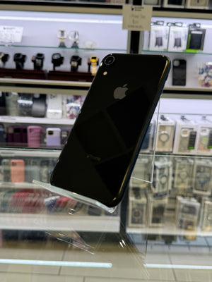Black smartphone with Apple logo on a reflective surface