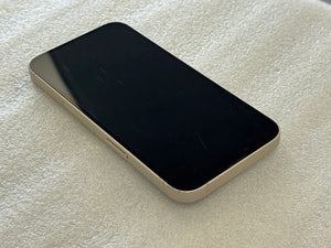 Apple smartphone with a black screen on a textured white surface