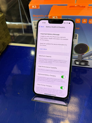 Smartphone displaying battery health information on a blue surface with K3 product packaging in the background.