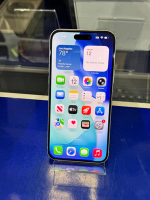 Smartphone with app icons displayed on a reflective surface