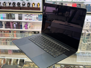 Laptop on a reflective surface with a store interior in the background
