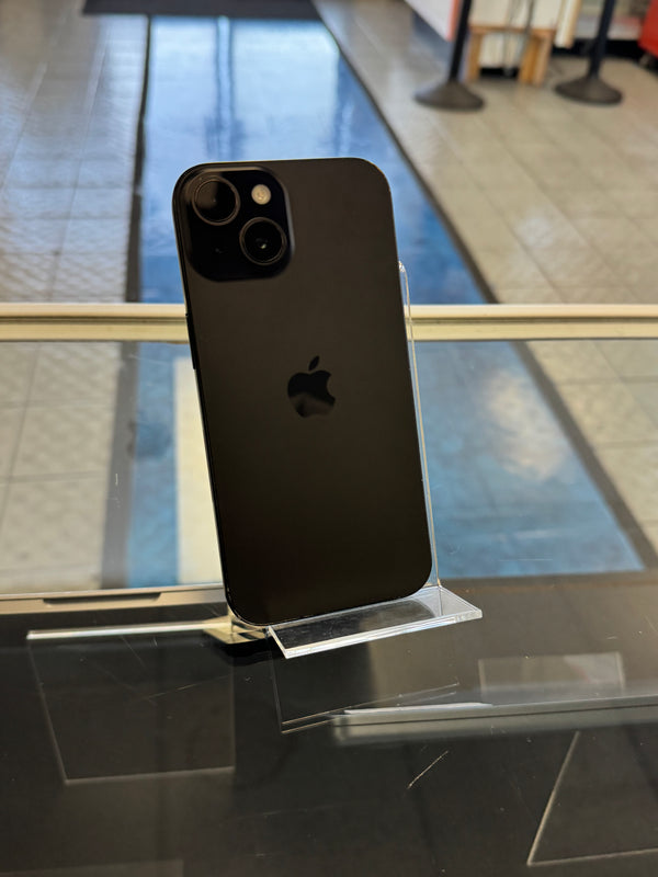 Black smartphone on a stand with blurred indoor background