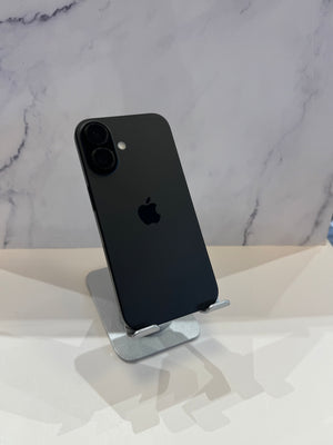A black Apple iPhone with a dual-camera system, displayed on a silver metal stand against a white marble-patterned background.