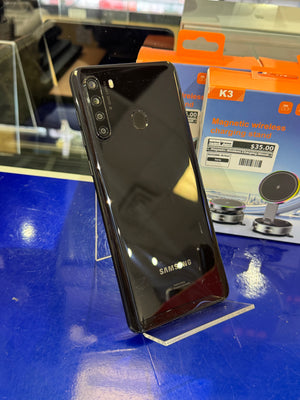 Samsung smartphone on a blue surface with packaging in the background