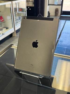 Silver Apple product on display with a blurred indoor background