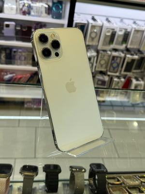 Silver iPhone 12 Pro Max on display with a blurred store interior background