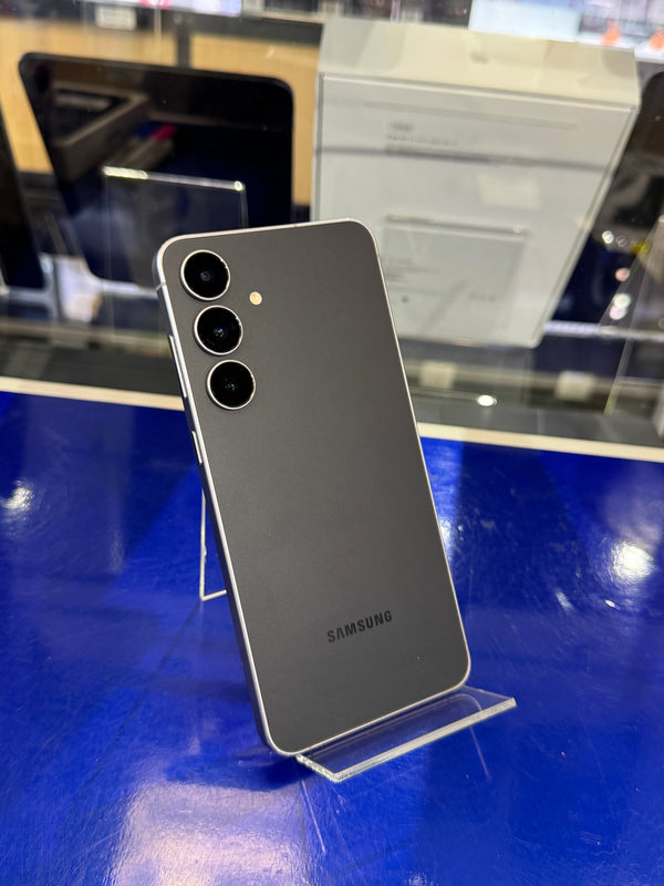 Samsung smartphone on a stand with a blue surface and blurred background