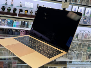 Laptop on display in a store with various products in the background