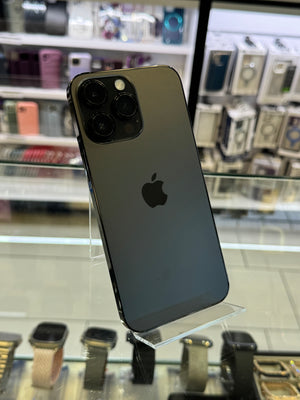 Black smartphone on a stand with blurred store shelves in the background