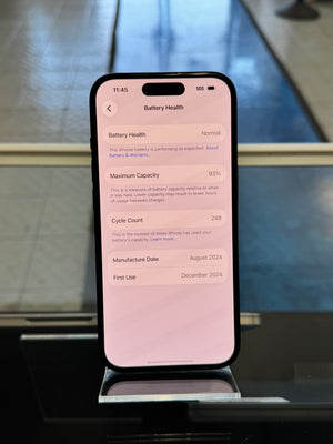 Smartphone displaying battery health information on a reflective surface