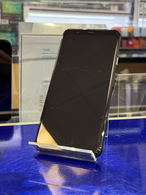 Black smartphone with a reflective surface on a blue stand