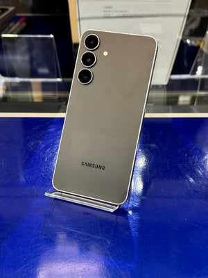 Samsung smartphone on a stand with a blue surface in the background