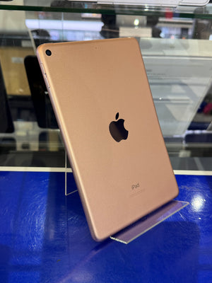 Gold Apple iPad Pro on display with a blue background