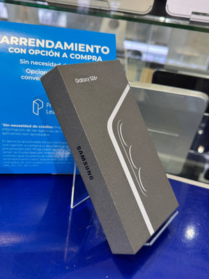 Samsung Galaxy S24 Ultra smartphone box in dark gray packaging, resting on a blue display stand in a retail setting.
