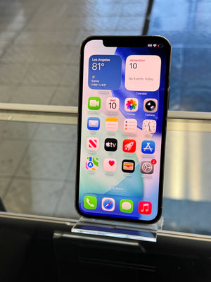 Smartphone with app icons displayed on a stand against a blurred background
