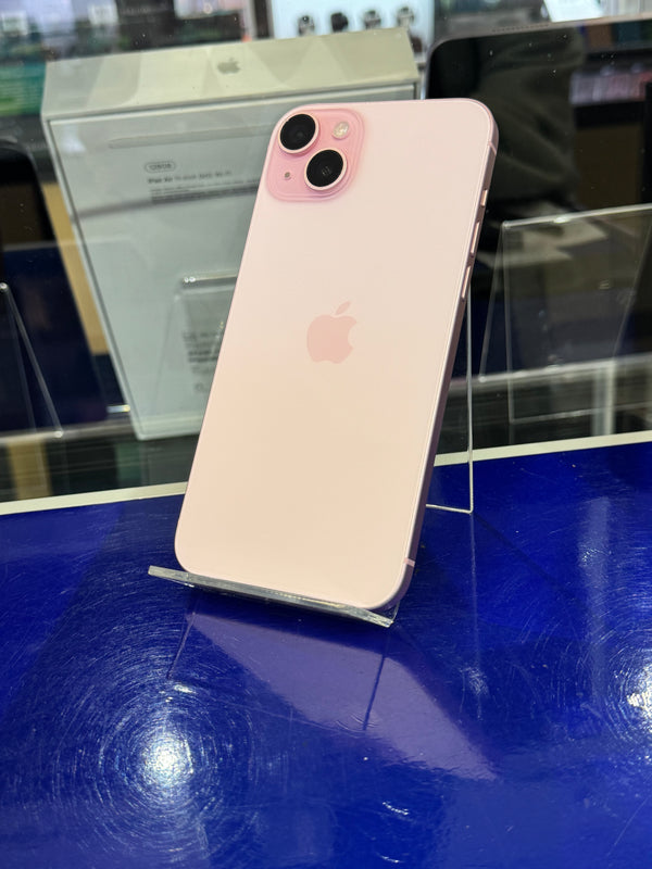 Pink Apple smartphone on a blue surface with reflection