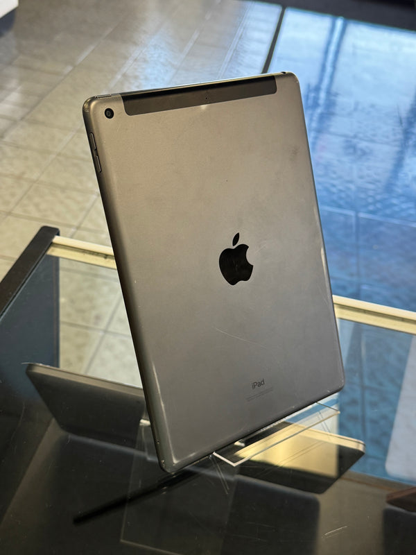 Silver Apple product on a reflective surface with blurred background