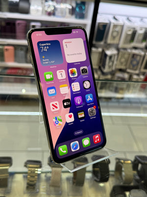 Smartphone with app icons displayed on a reflective surface